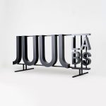 Black metal floating letter shelf sign for the San Francisco office of Juul, an electronic cigarette company.