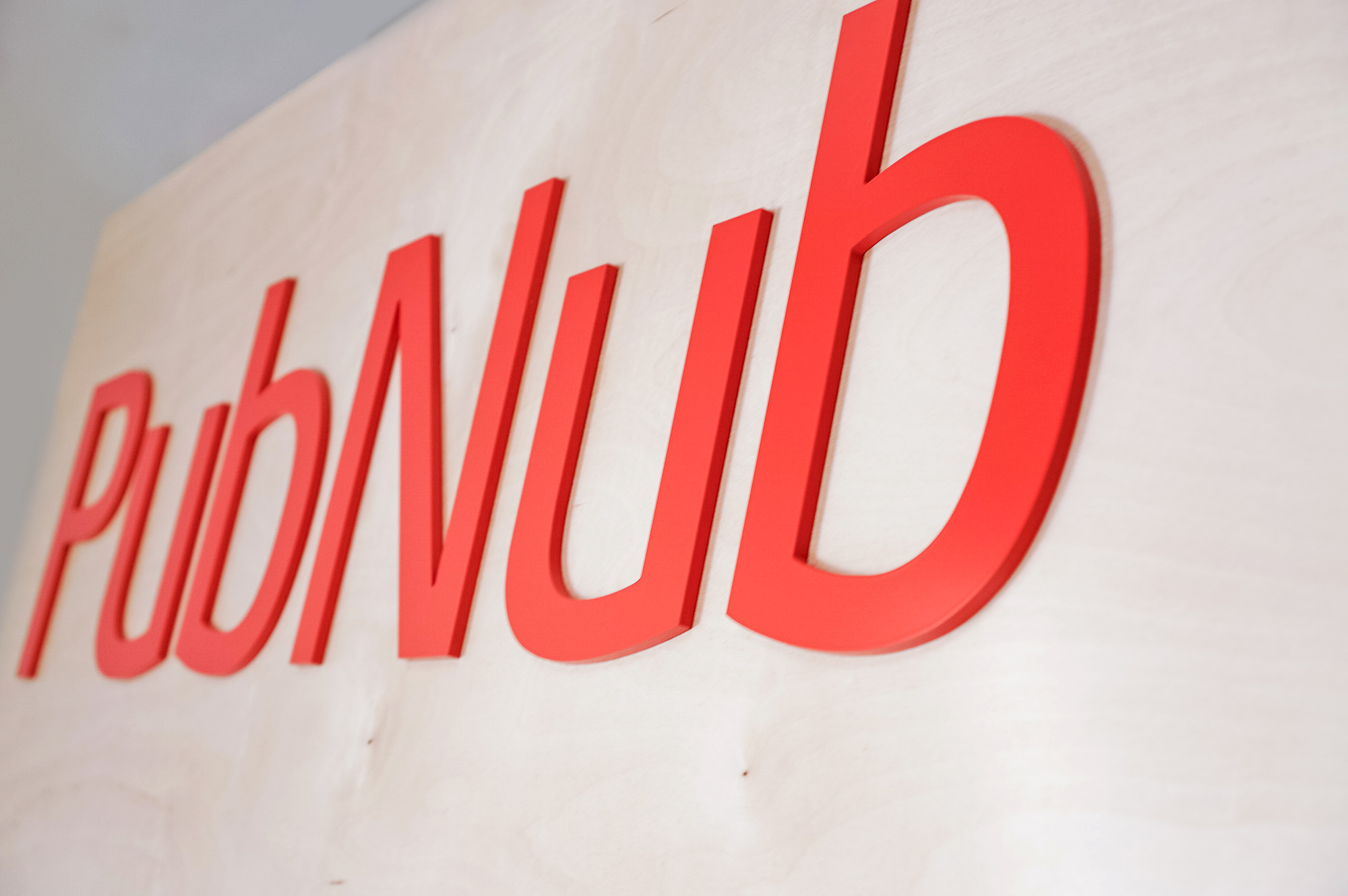 Light wood sign with red letters for PubNub, a global Data Stream Network and realtime infrastructure-as-a-service company based in San Francisco, California.
