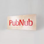 Light wood sign with red letters for PubNub, a global Data Stream Network and realtime infrastructure-as-a-service company based in San Francisco, California.