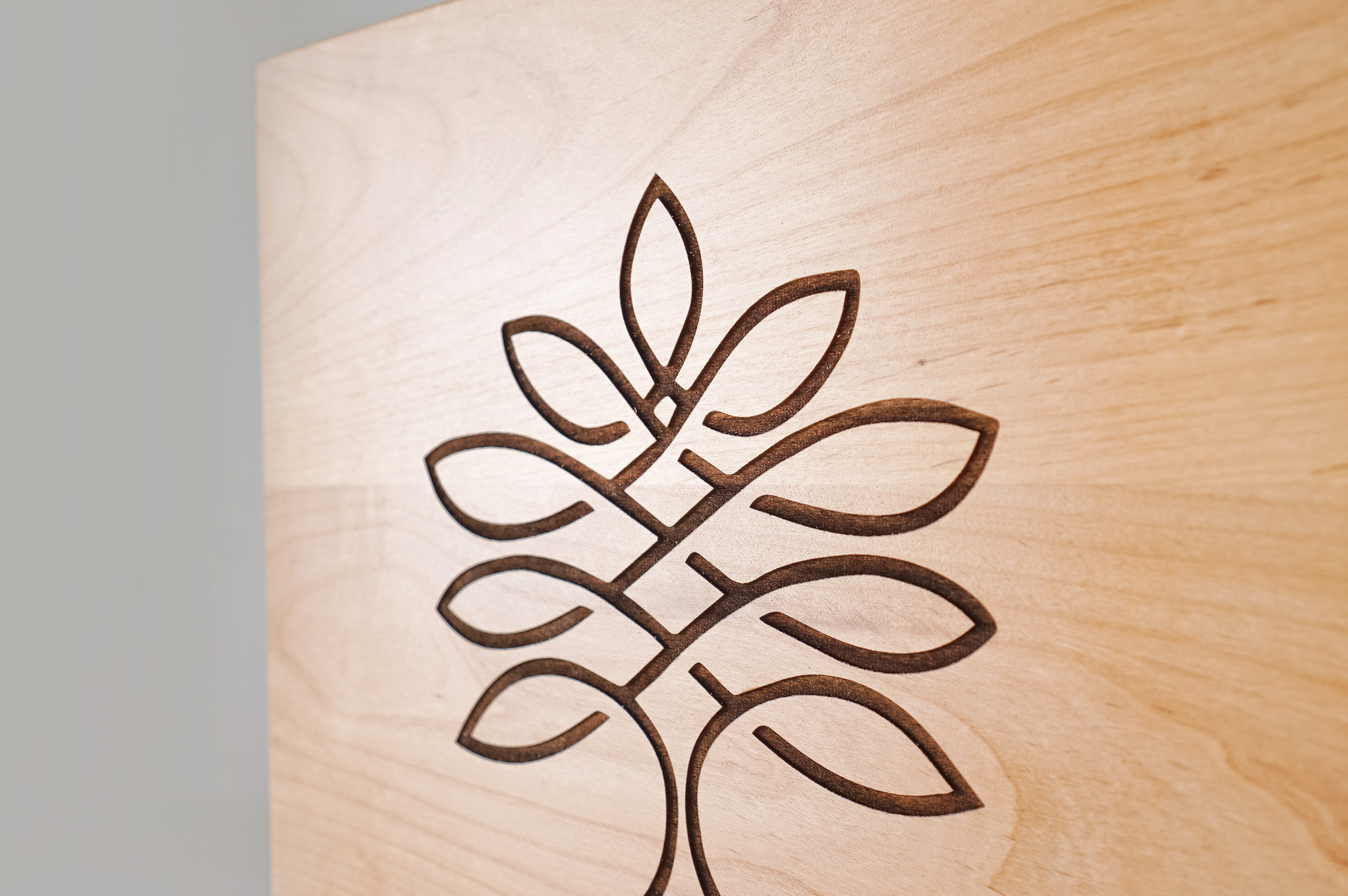 Etched light wood sign for Rosewood Family Advisors, a Palo Alto based company offering a diverse range of family office services.