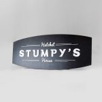 Black and white raised panel sign for Stumpy's, the first hatchet throwing venue in the U.S.