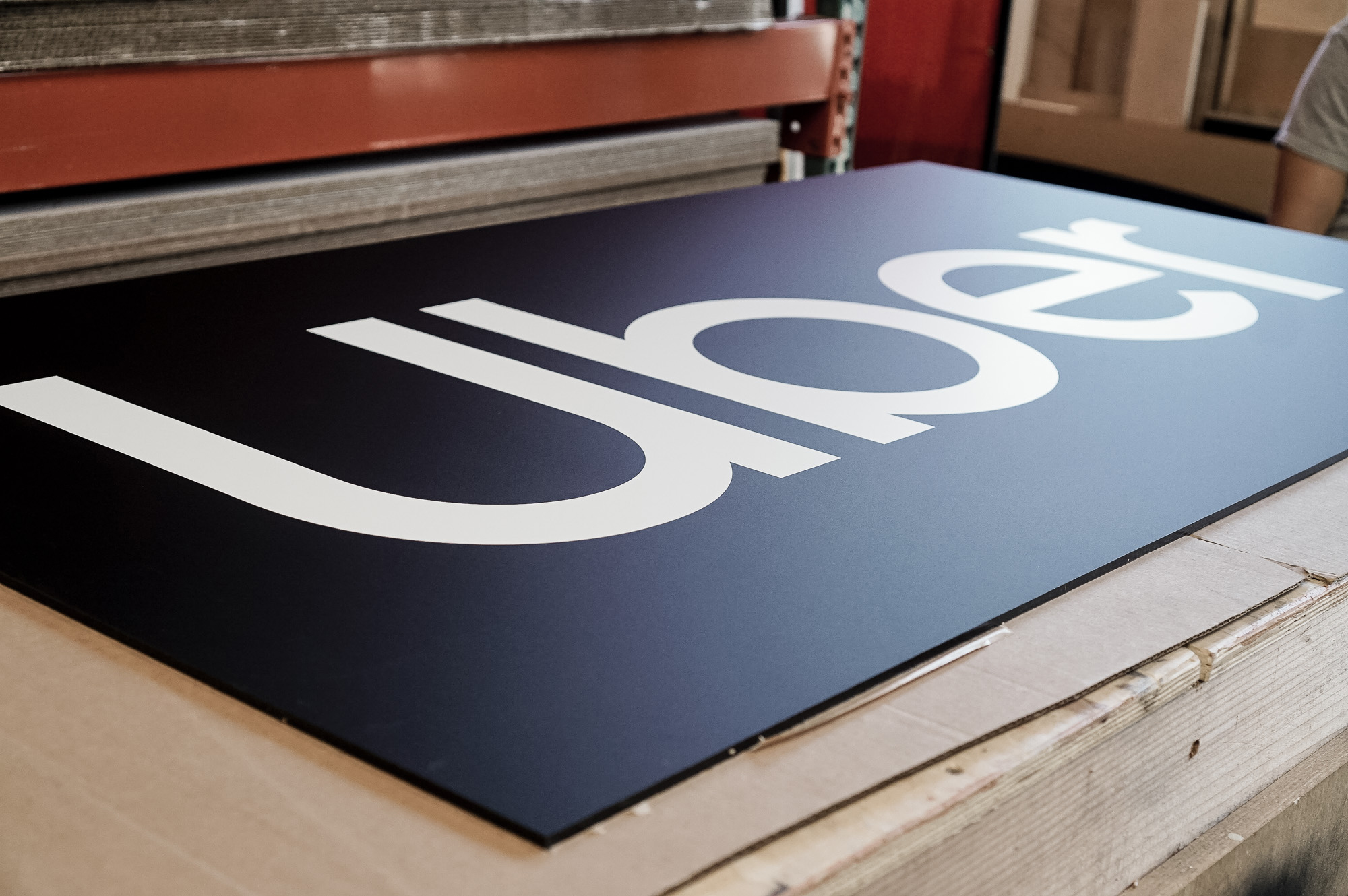 Black and white lobby sign for Uber, an American multinational transportation network company. Black and white lobby sign for Uber, an American multinational transportation network company.