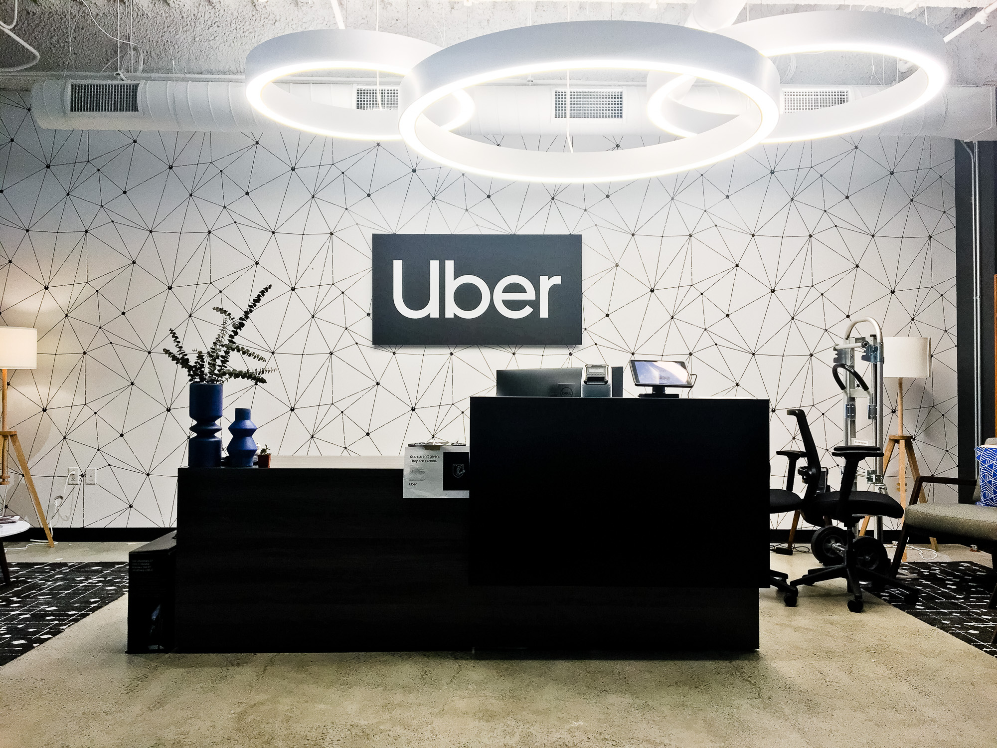 Black and white lobby sign for Uber, an American multinational transportation network company. Black and white lobby sign for Uber, an American multinational transportation network company.