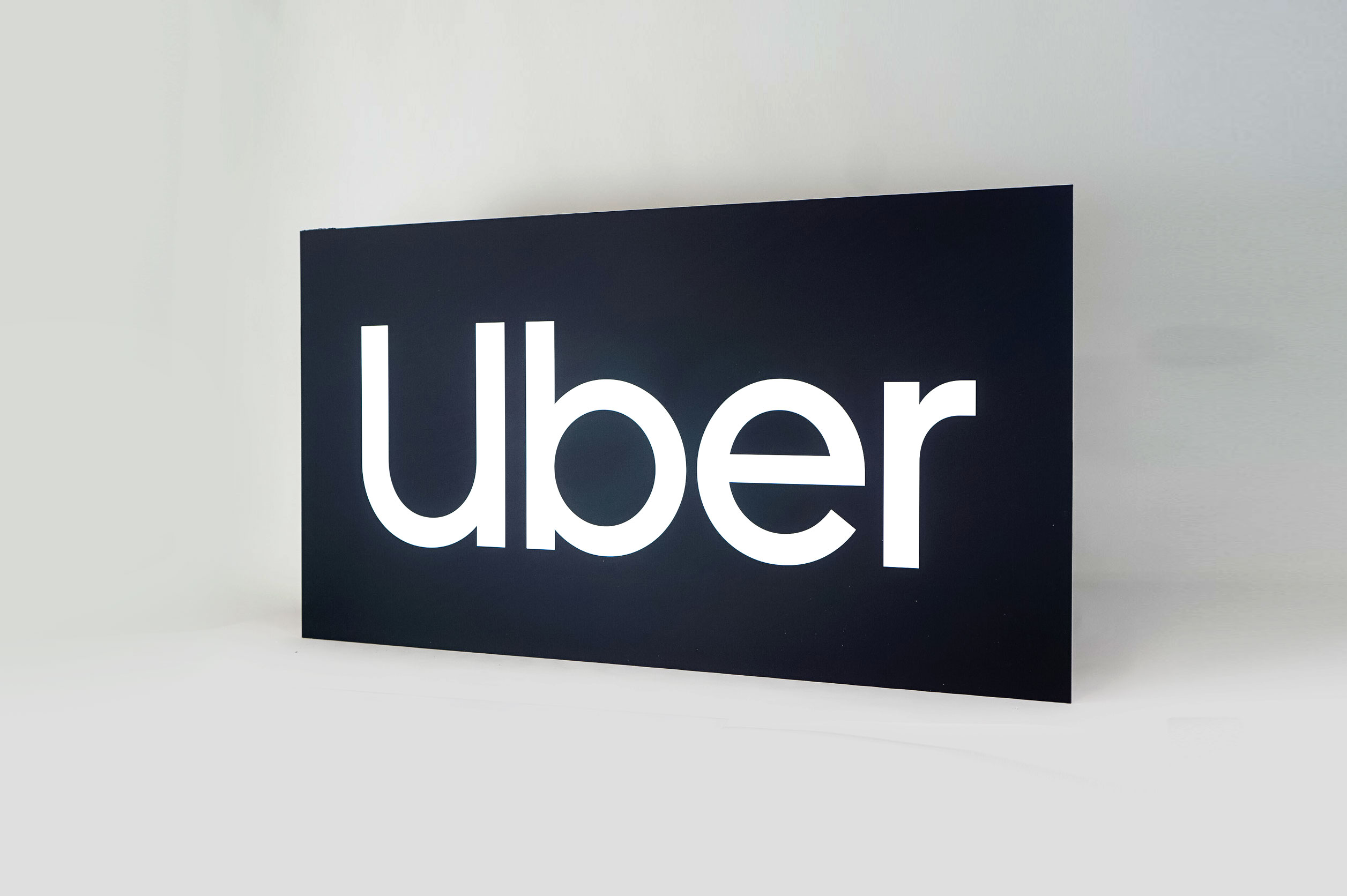 Black and white lobby sign for Uber, an American multinational transportation network company. Black and white lobby sign for Uber, an American multinational transportation network company.