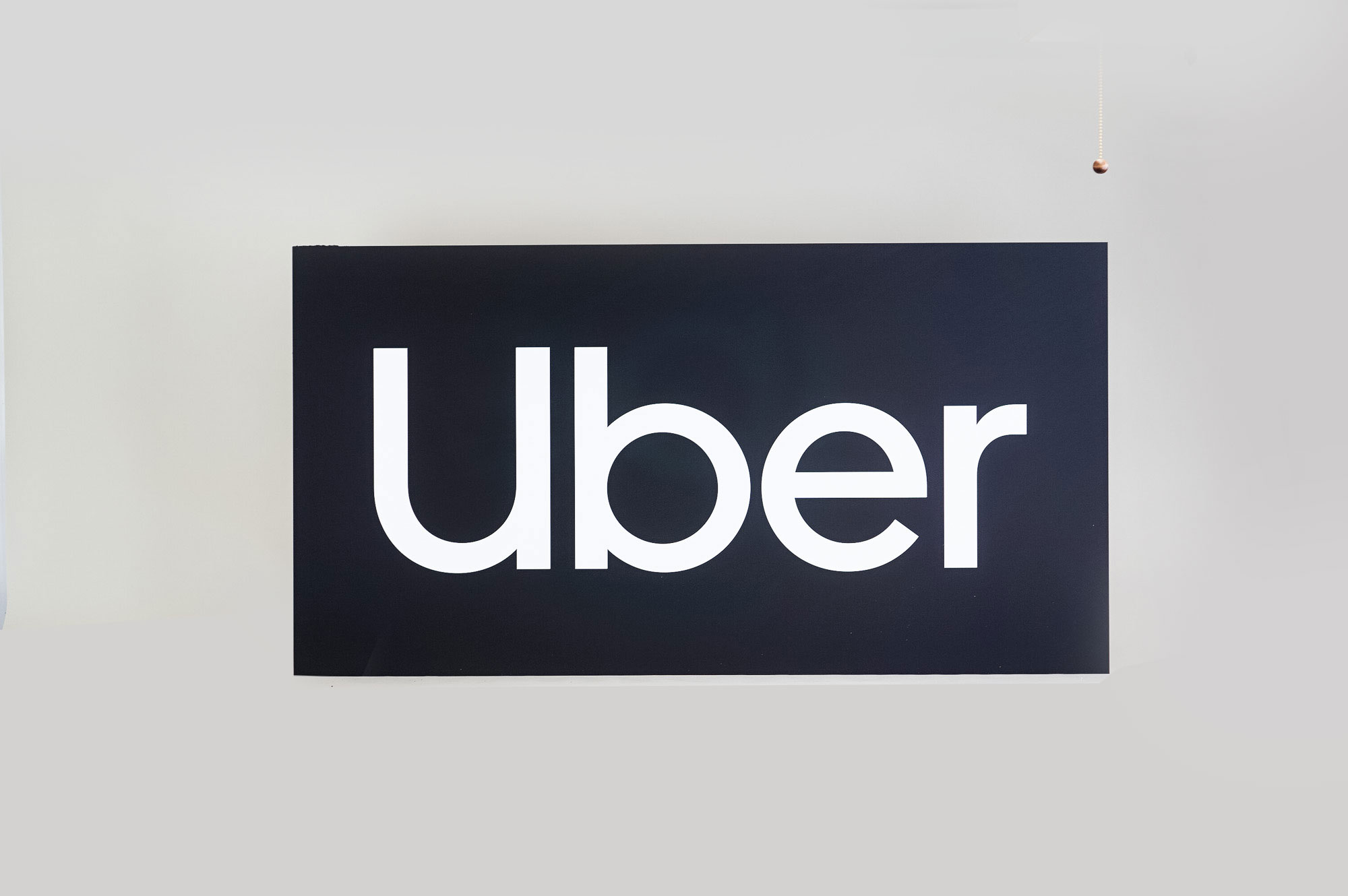 Black and white lobby sign for Uber, an American multinational transportation network company. Black and white lobby sign for Uber, an American multinational transportation network company.