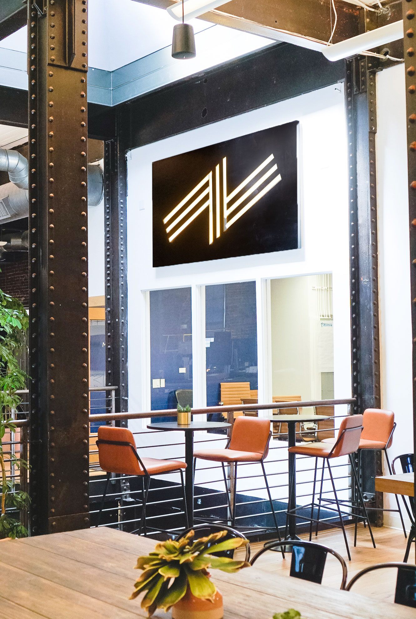 Illuminated black wood sign with warm light on the atrium wall of Zeus, a San Francisco based company providing beautiful, fully furnished homes for business travelers staying one month or longer. Illuminated black wood sign with warm light on the atrium wall of Zeus, a San Francisco based company providing beautiful, fully furnished homes for business travelers staying one month or longer.