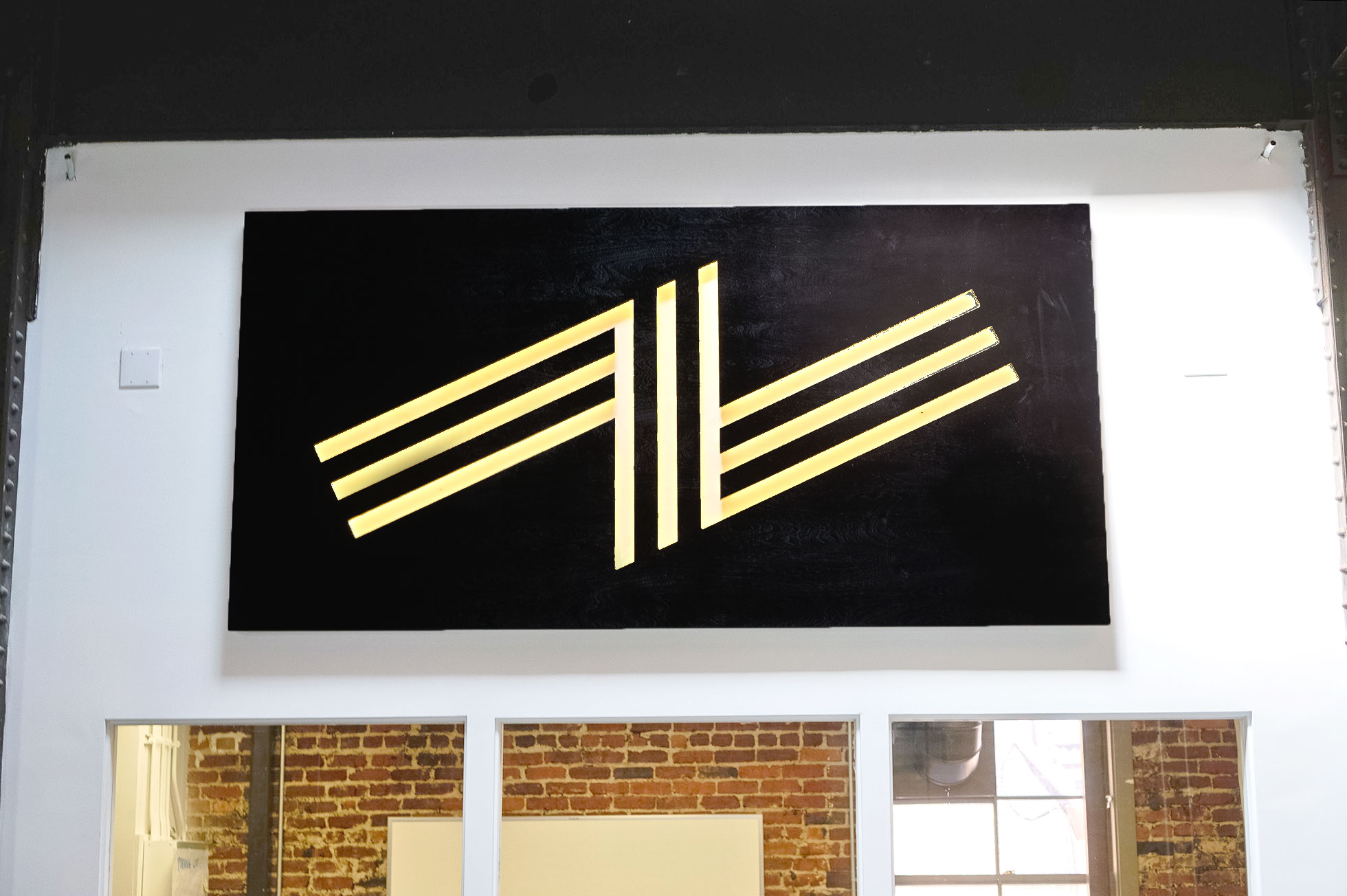 Illuminated black wood sign with warm light on the atrium wall of Zeus, a San Francisco based company providing beautiful, fully furnished homes for business travelers staying one month or longer. Illuminated black wood sign with warm light on the atrium wall of Zeus, a San Francisco based company providing beautiful, fully furnished homes for business travelers staying one month or longer.