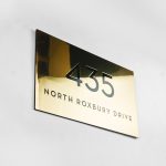 Classic style, solid brass exterior address sign for Mickey's Fine Pharmacy, a Beverly Hills landmark.