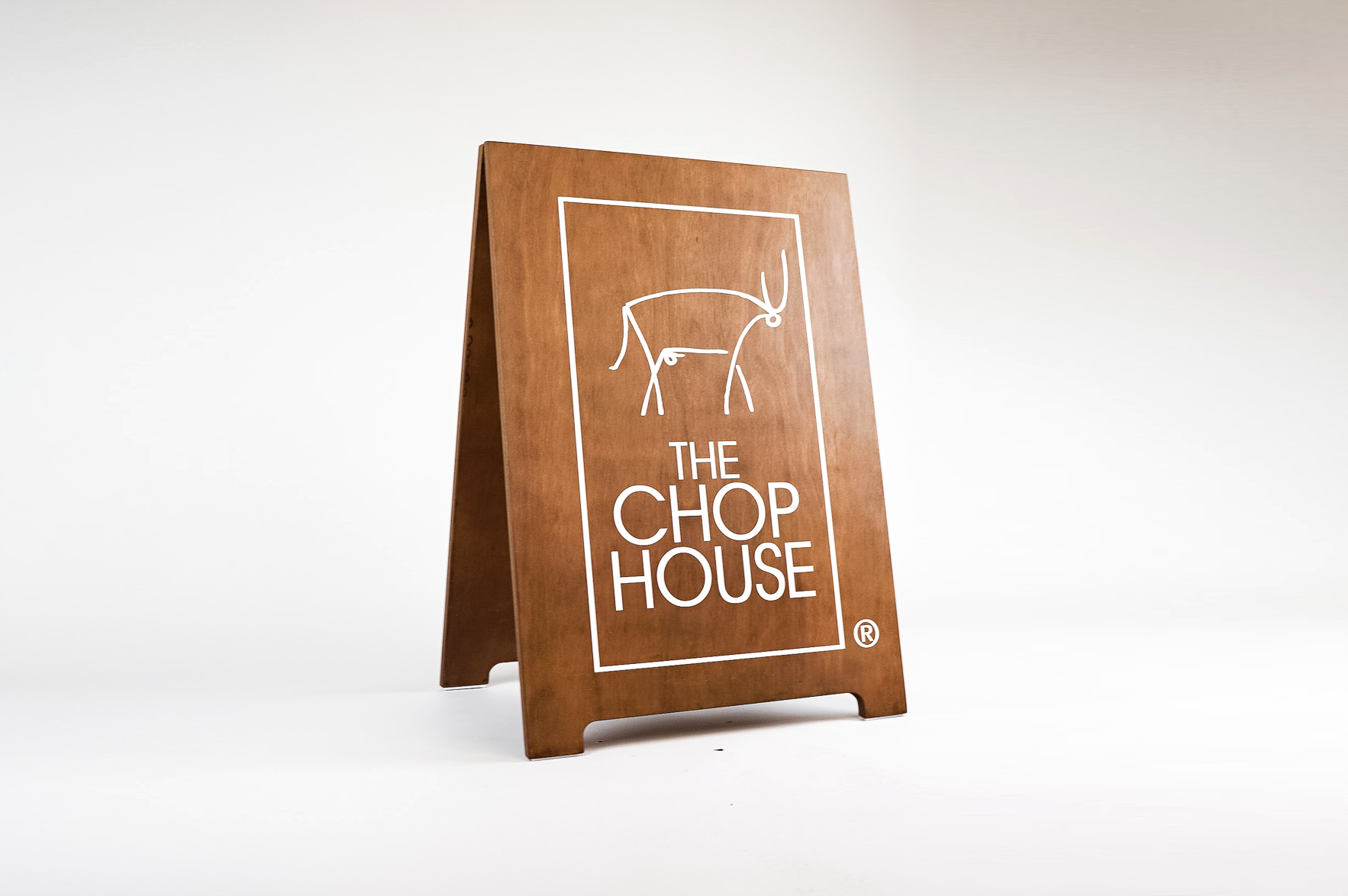 Dark wood sidewalk A-frame sign with white logo for The Chop House, a bar and lounge in Toledo, Ohio. Dark wood sidewalk A-frame sign with white logo for The Chop House, a bar and lounge in Toledo, Ohio.