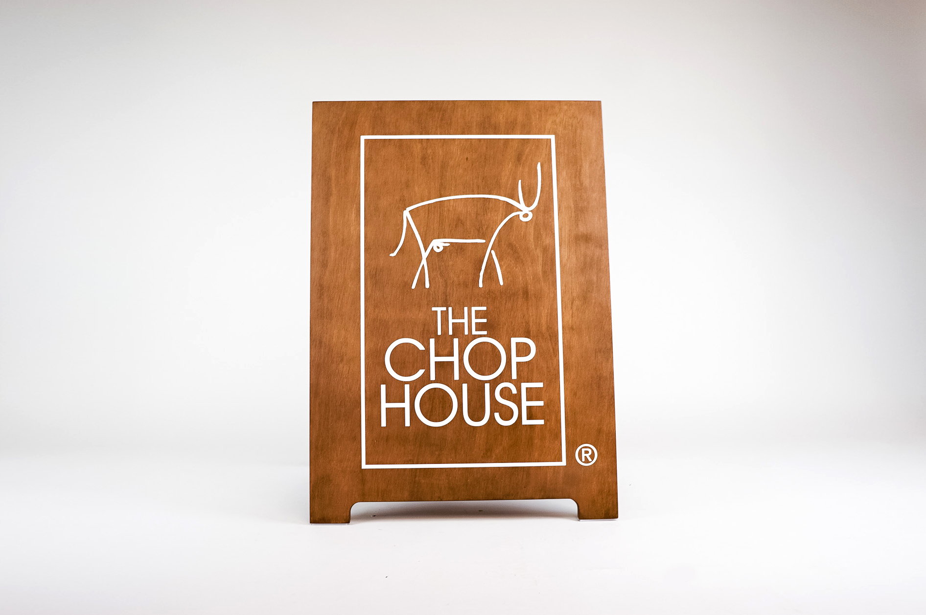 Dark wood sidewalk A-frame sign with white logo for The Chop House, a bar and lounge in Toledo, Ohio. Dark wood sidewalk A-frame sign with white logo for The Chop House, a bar and lounge in Toledo, Ohio.