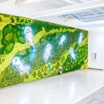 Illuminated, neon-style jellyfish on moss wall at the office of Benchling, a San Francisco based company working on a unified platform to accelerate, measure, and forecast R&D from discovery through bioprocessing.