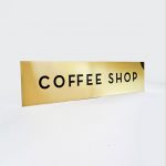 Classic style, solid brass coffee shop sign for Mickey's Fine Pharmacy, a Beverly Hills landmark.