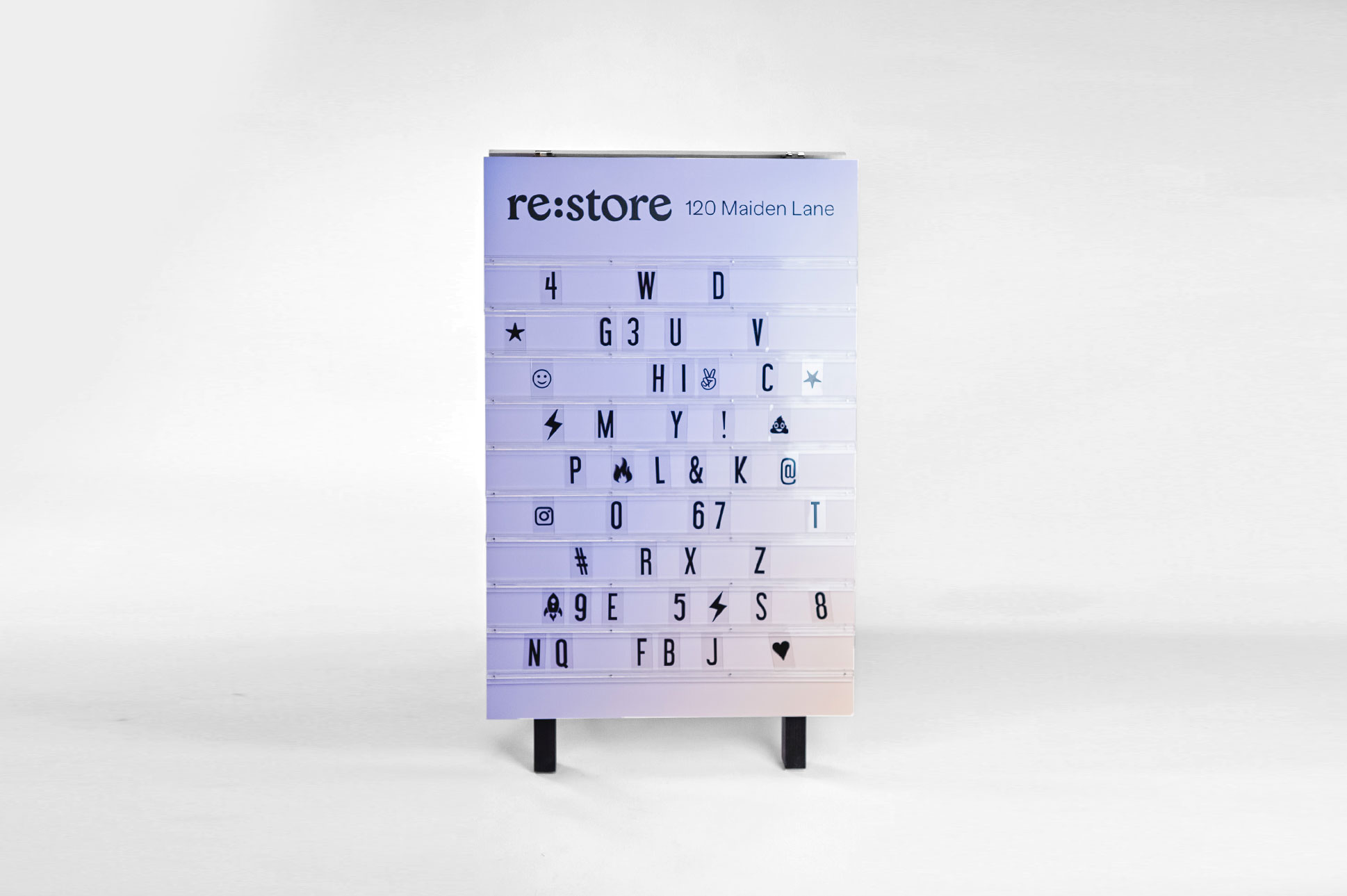 Gradient purple and peach A-frame sign with changeable letters for Re:Store, a retail store and community space on Maiden Lane in San Francisco, CA. Gradient purple and peach A-frame sign with changeable letters for Re:Store, a retail store and community space on Maiden Lane in San Francisco, CA.