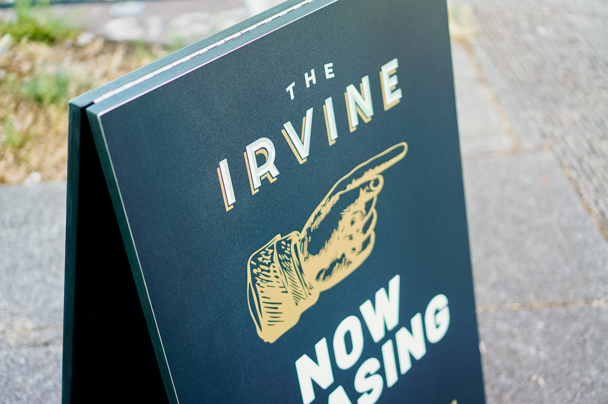 Emerald green and gold A-frame sign for The Irvine, a luxury apartment building in Philadelphia. Emerald green and gold A-frame sign for The Irvine, a luxury apartment building in Philadelphia.