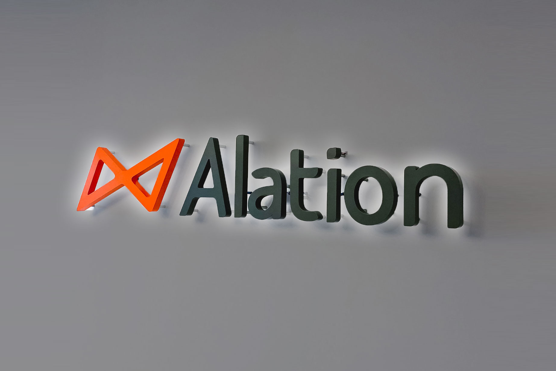 Illuminated black and orange lobby sign on color blocked wall for Alation, a data catalog company based in Redwood City, CA Illuminated black and orange lobby sign on color blocked wall for Alation, a data catalog company based in Redwood City, CA