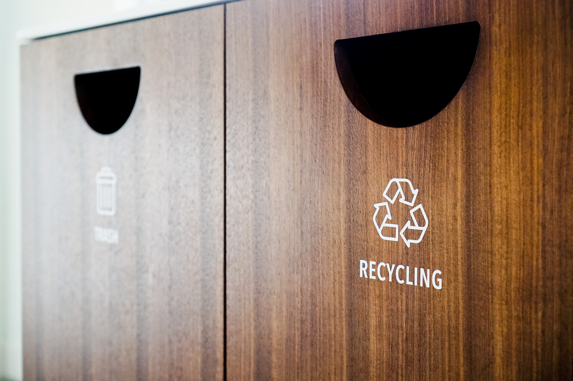 Minimal white vinyl signage /decals for wood trash, compost, and recycling bins at the office of Baker McKenzie, a multinational law firm. Minimal white vinyl signage /decals for wood trash, compost, and recycling bins at the office of Baker McKenzie, a multinational law firm.