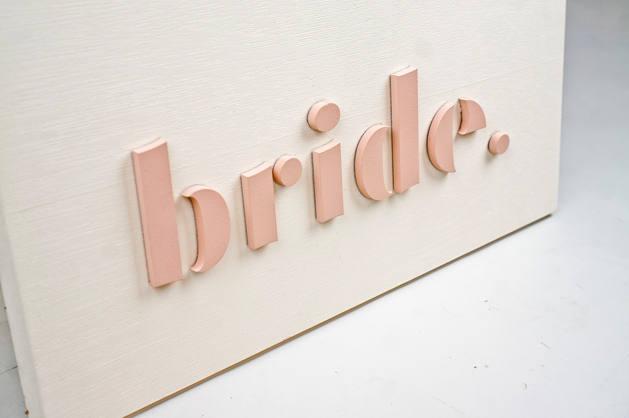 Blush-colored blade sign for Bride, a bridal shop in Kansas City, Missouri. Blush-colored blade sign for Bride, a bridal shop in Kansas City, Missouri.