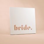 Blush-colored blade sign for Bride, a bridal shop in Kansas City, Missouri.