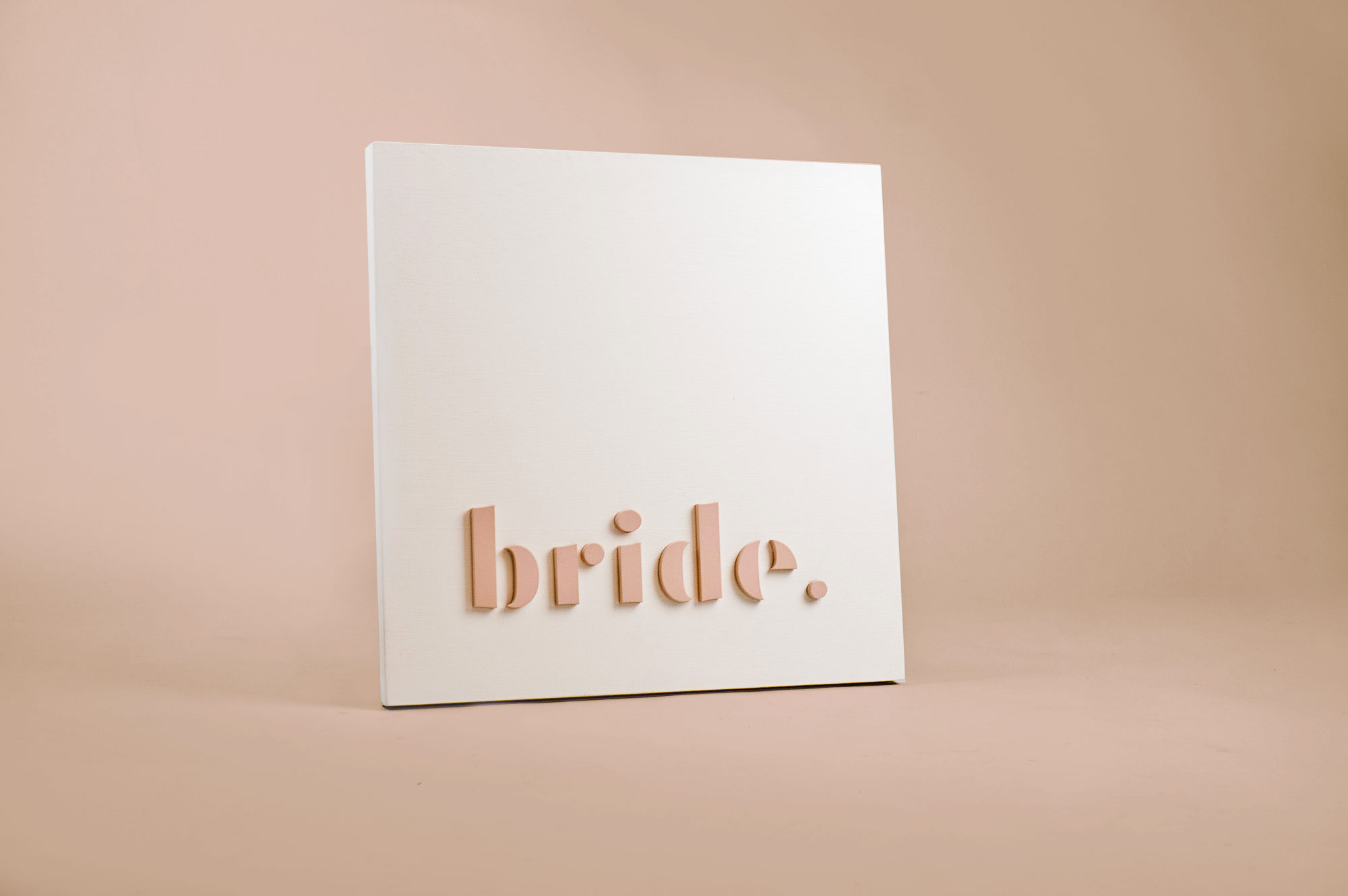 Blush-colored blade sign for Bride, a bridal shop in Kansas City, Missouri. Blush-colored blade sign for Bride, a bridal shop in Kansas City, Missouri.