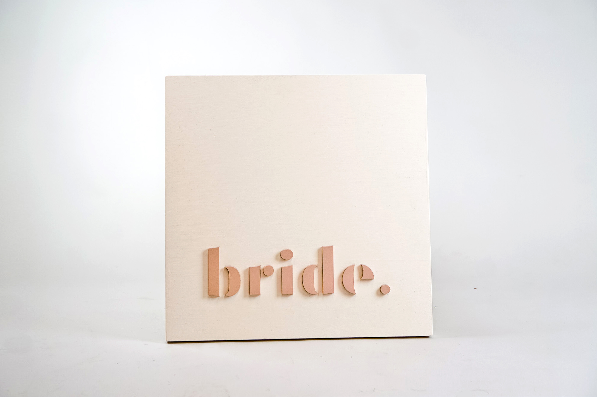 Blush-colored blade sign for Bride, a bridal shop in Kansas City, Missouri. Blush-colored blade sign for Bride, a bridal shop in Kansas City, Missouri.