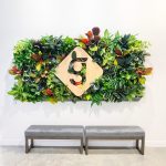 Light wood sign with colored edges on living wall for the lobby of Getaround, an online car sharing or peer-to-peer carsharing service.