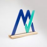 Freestanding blue and green logo on wood base for the office of MyVest, a company building enterprise wealth management technology for the digital age.