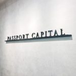 Black letters on shelf against concrete lobby wall at Passport Capital, a San Francisco-based, global thematic investment firm.