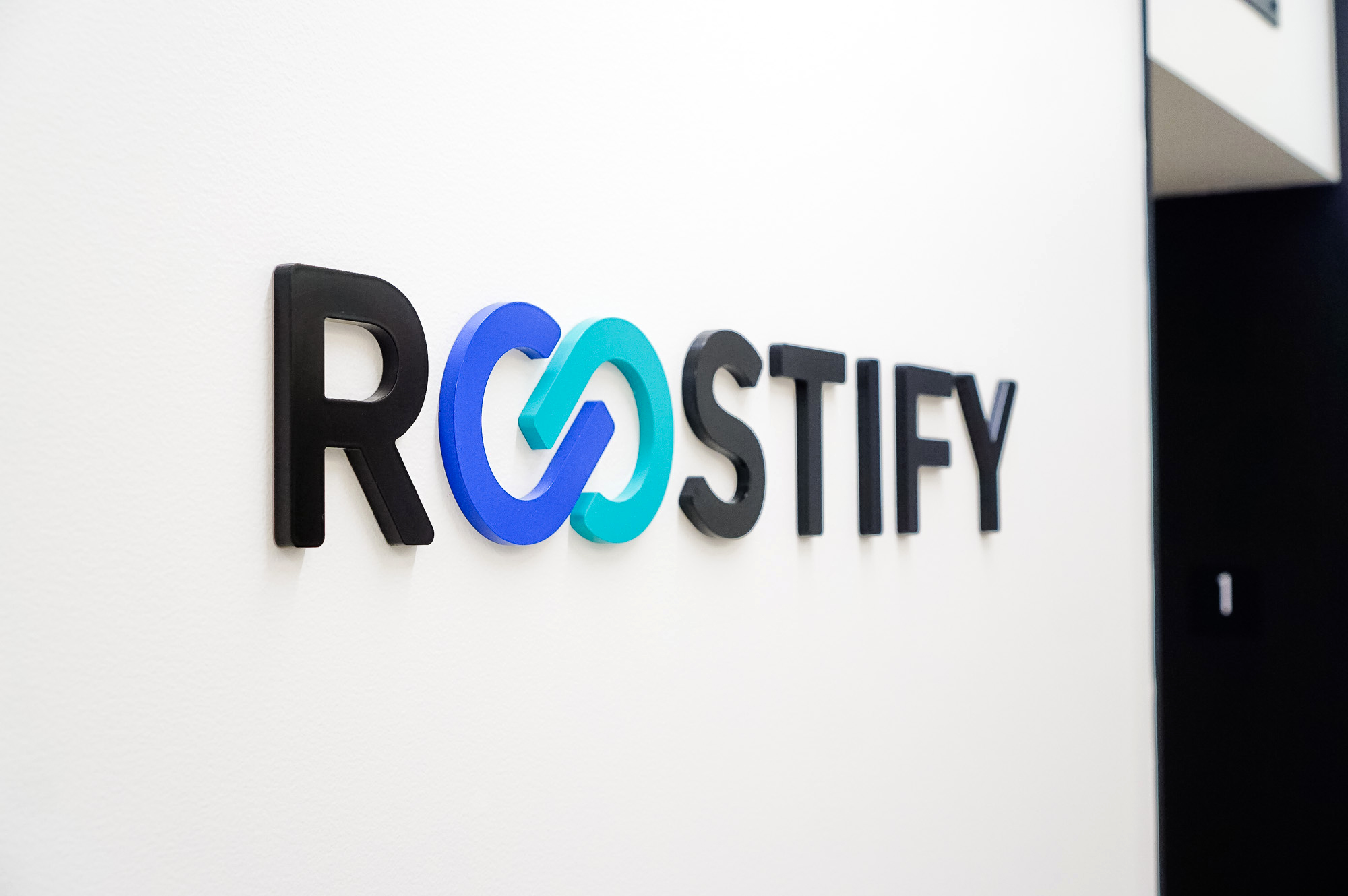 Dimensional, full color logo on white wall in lobby and elevator vestibule for the San Francisco office of Roostify, an integrated digital mortgage software platform. Dimensional, full color logo on white wall in lobby and elevator vestibule for the San Francisco office of Roostify, an integrated digital mortgage software platform.