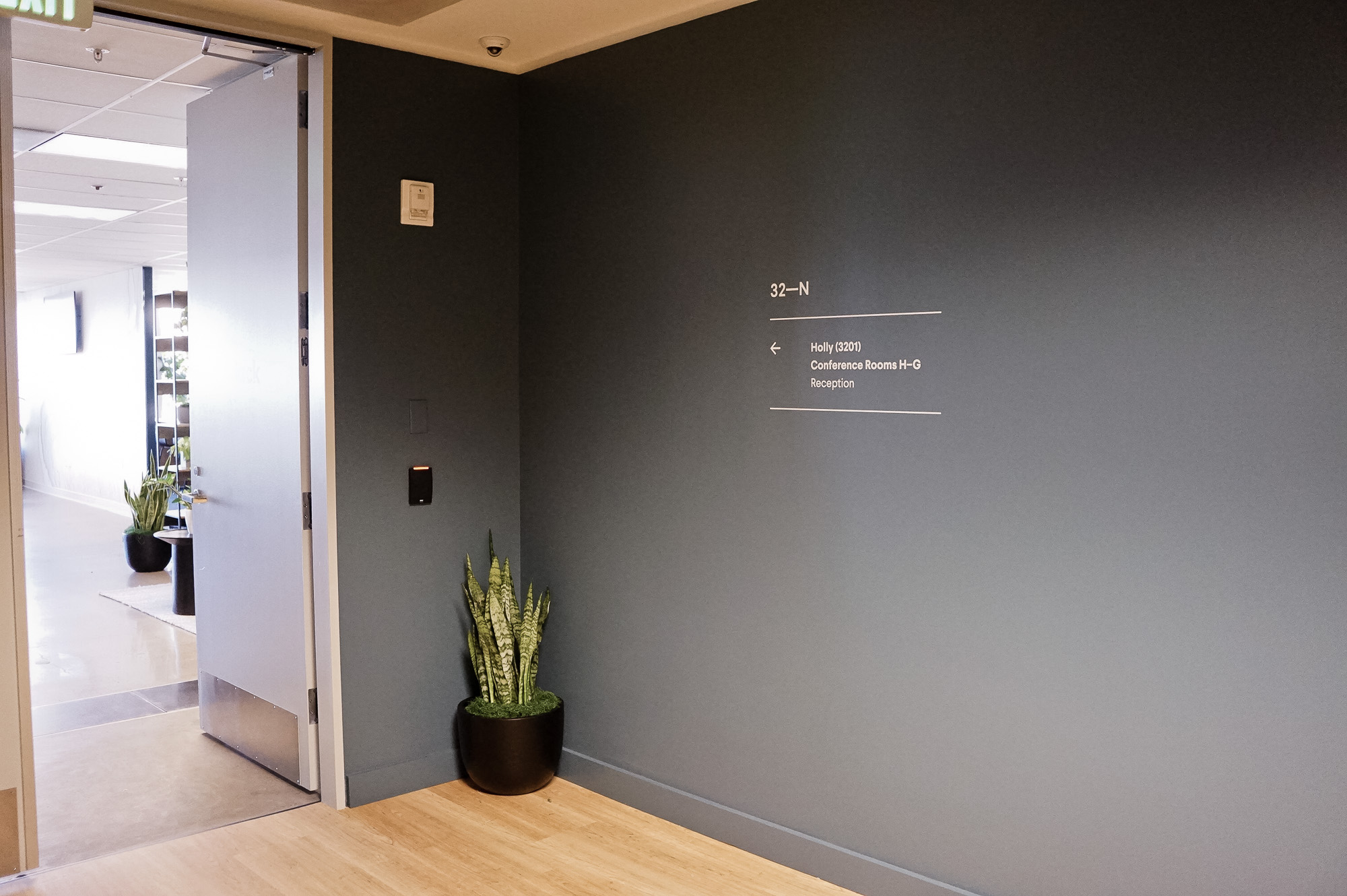 Matte white vinyl wayfinding sign with white text for a San Francisco office of Slack, an American cloud-based set of proprietary team collaboration tools and services. Matte white vinyl wayfinding sign with white text for a San Francisco office of Slack, an American cloud-based set of proprietary team collaboration tools and services.