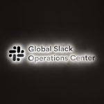 Brushed metal sign with edge lit lighting for the operations center of Slack, an American cloud-based set of team collaboration tools and services.