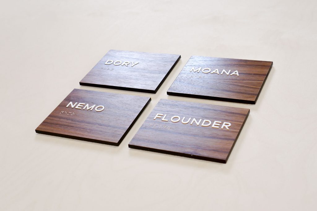 Luxe walnut wood ADA meeting/conference room signs for the office of Aquatic, a research and development company based in Chicago, IL.