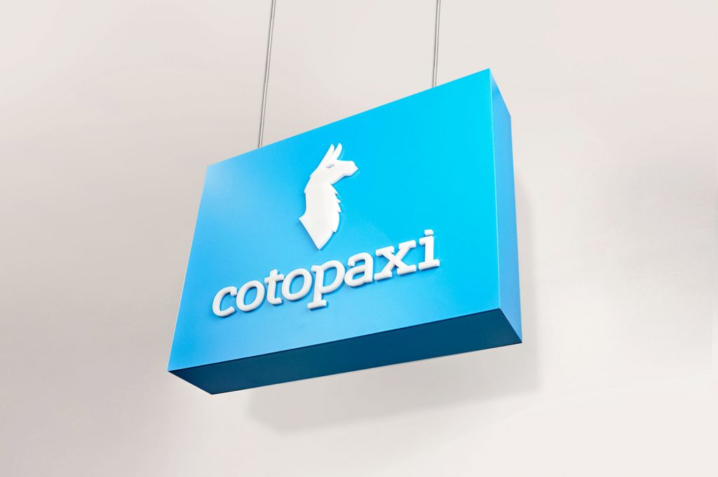 Blue boxed overhead retail sign with white artwork for Cotopaxi, a company that creates innovative outdoor products and experiences.