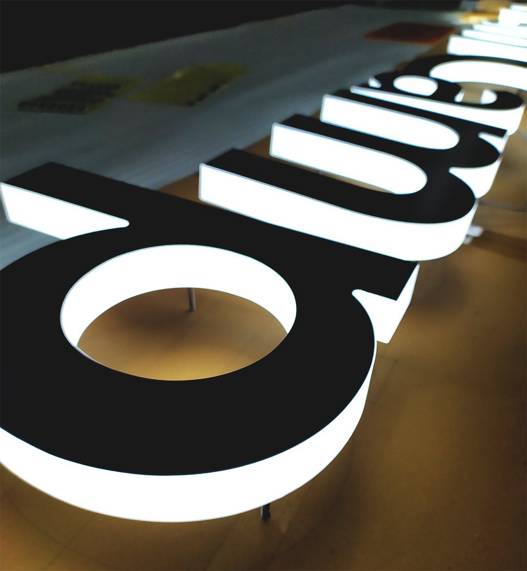 Brushed metal sign with edge lit lighting for the operations center of Slack, an American cloud-based set of team collaboration tools and services.