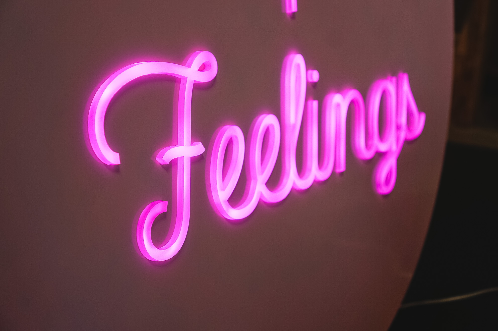 Pink neon-style team sign for Facebook, an American online social media and social networking service company.