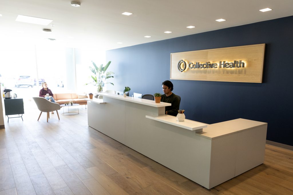 Illuminated wood and metal lobby sign for Collective Health in Lehi, Utah
