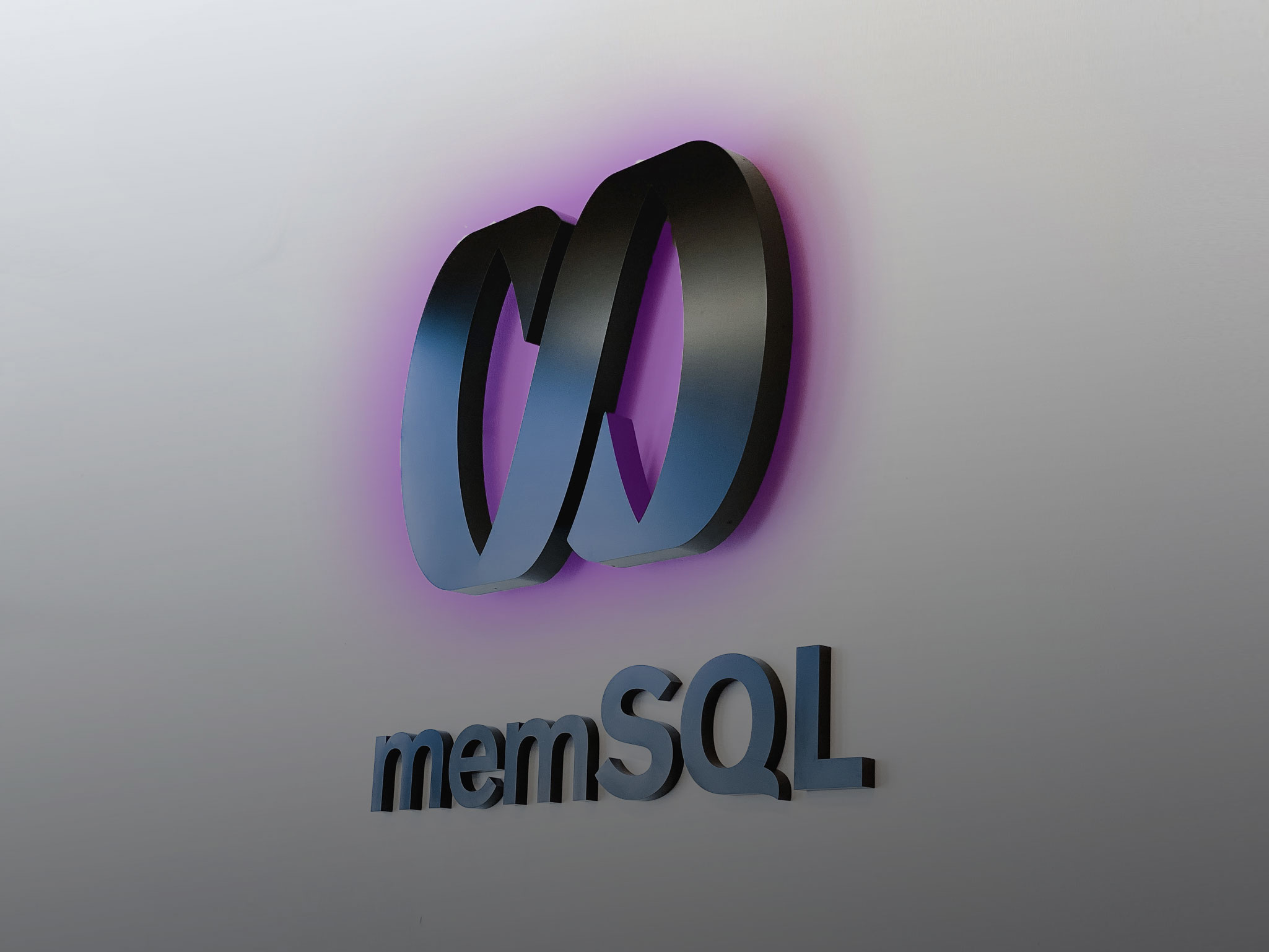 Illuminated black sign with back-lit purple lights for memSQL, a software company in San Francisco, California. Illuminated black sign with back-lit purple lights for memSQL, a software company in San Francisco, California.