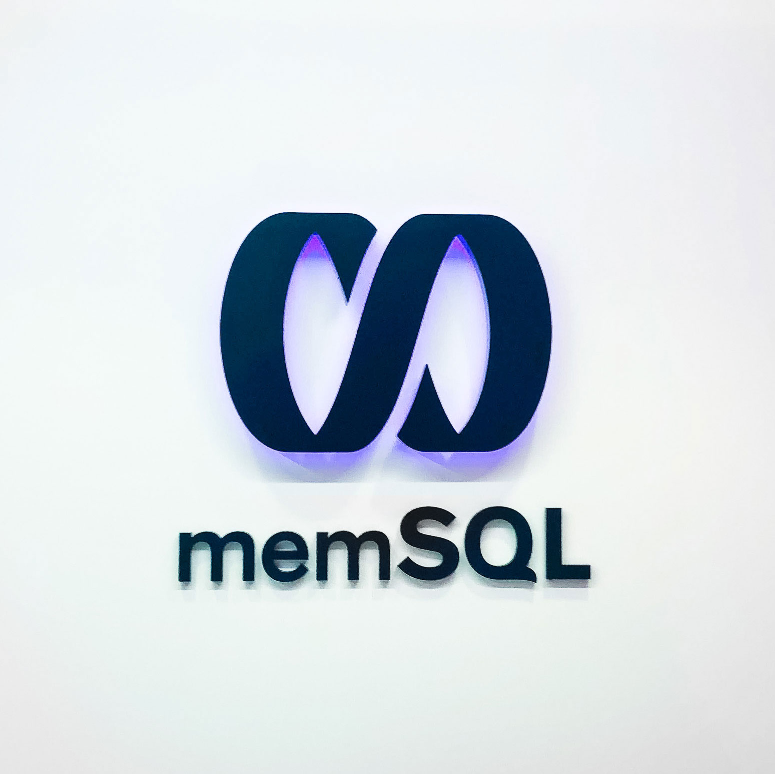 Illuminated black sign with back-lit purple lights for memSQL, a software company in San Francisco, California. Illuminated black sign with back-lit purple lights for memSQL, a software company in San Francisco, California.