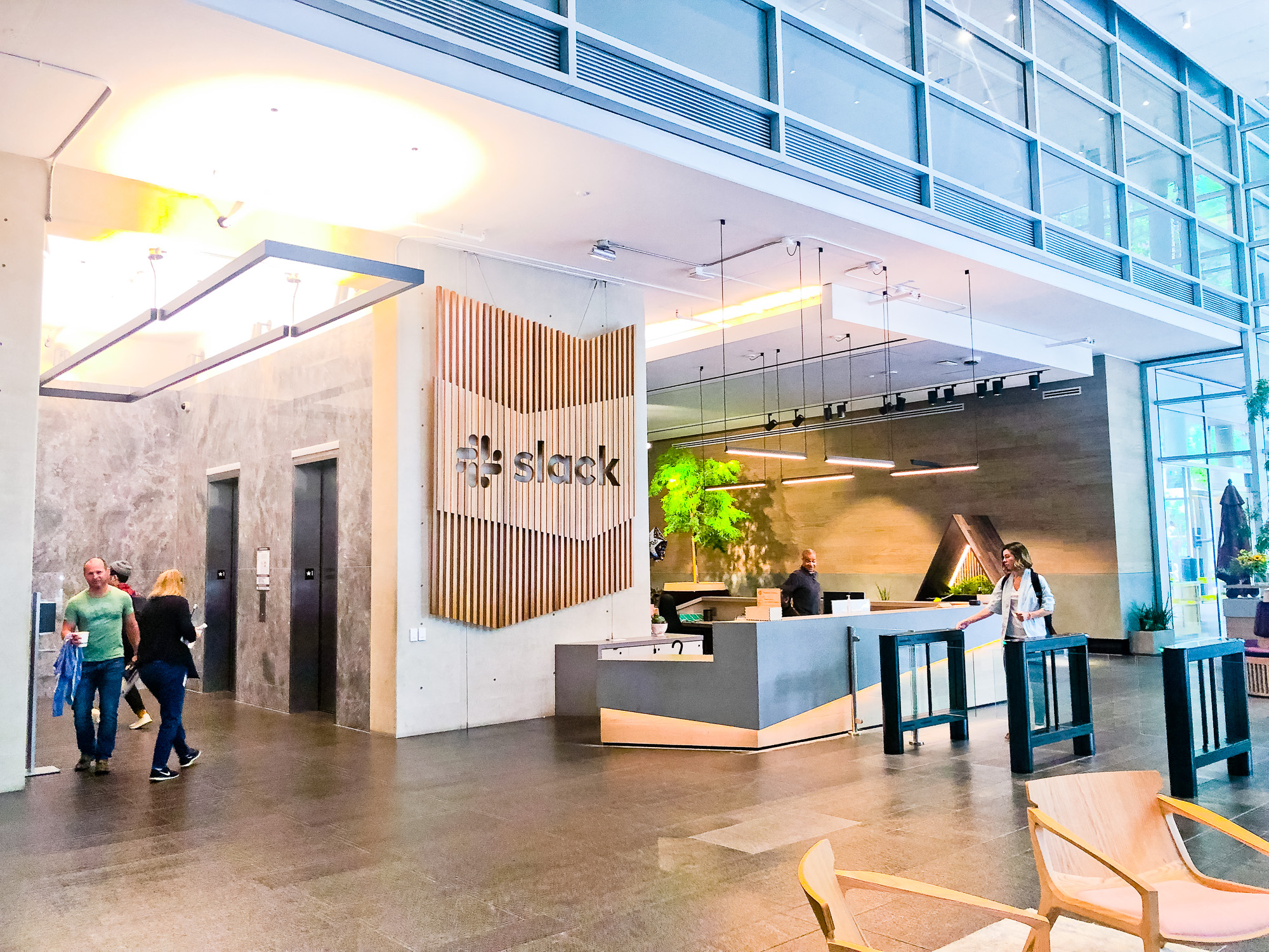 Modern, large-scale slat wood lobby sign on concrete wall at the San Francisco lobby of Slack, an American cloud-based set of team collaboration tools and services. Modern, large-scale slat wood lobby sign on concrete wall at the San Francisco lobby of Slack, an American cloud-based set of team collaboration tools and services.