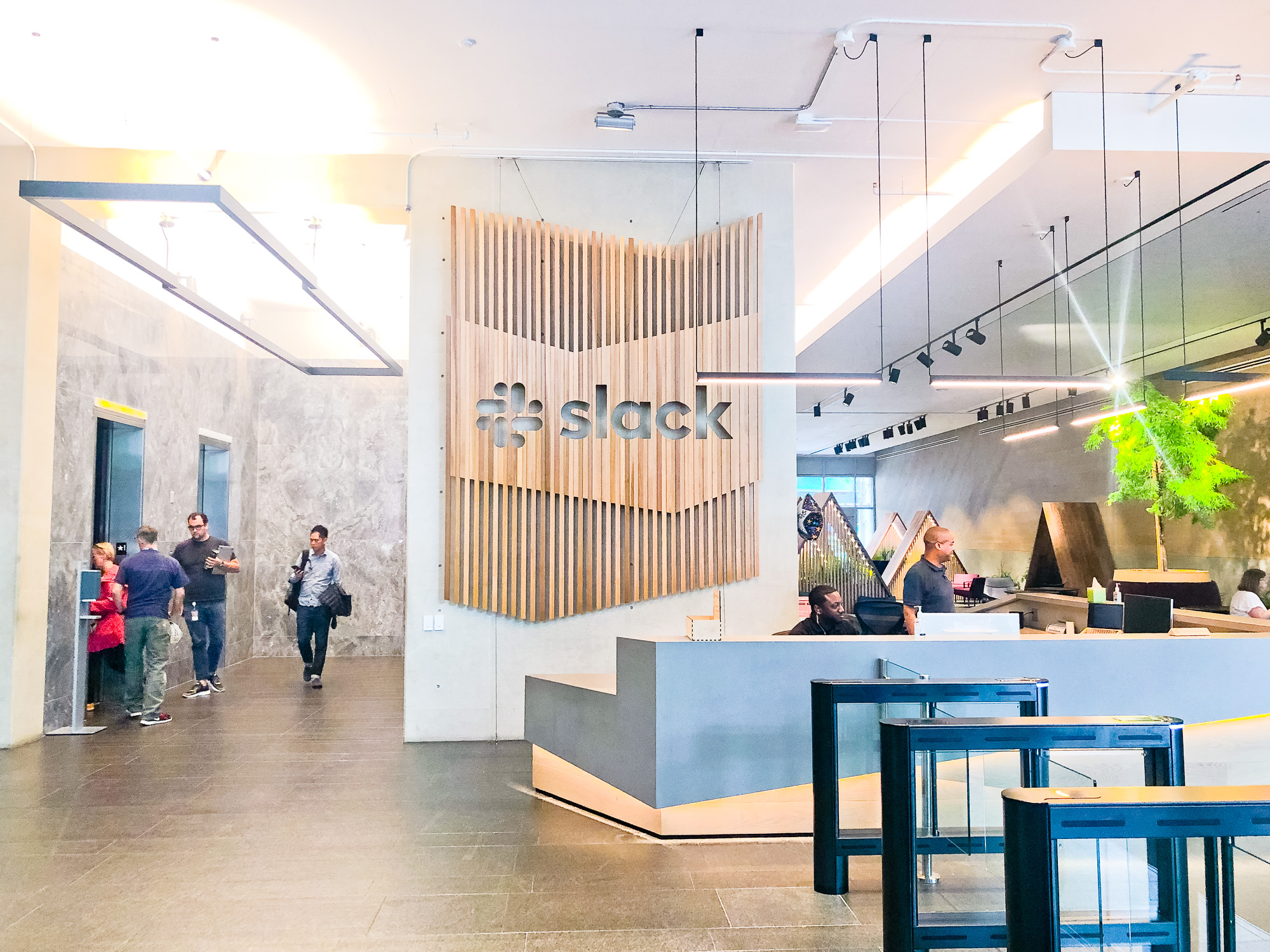Modern, large-scale slat wood lobby sign on concrete wall at the San Francisco lobby of Slack, an American cloud-based set of team collaboration tools and services. Modern, large-scale slat wood lobby sign on concrete wall at the San Francisco lobby of Slack, an American cloud-based set of team collaboration tools and services.