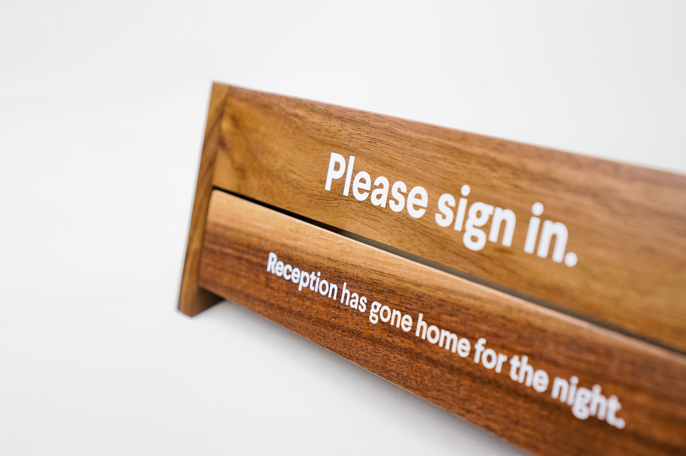 Rotating wood reception sign with various away messages for Slack, an American cloud-based set of team collaboration tools and services.