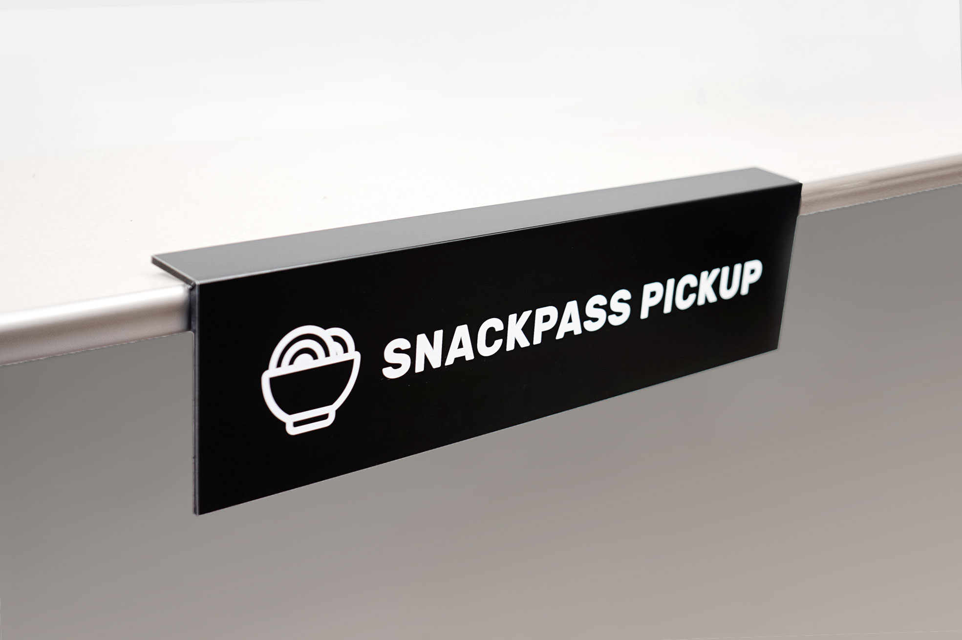 Overhanging black and white food pickup table sign for Snackpass, a social food app that makes ordering food more convenient, affordable and social.