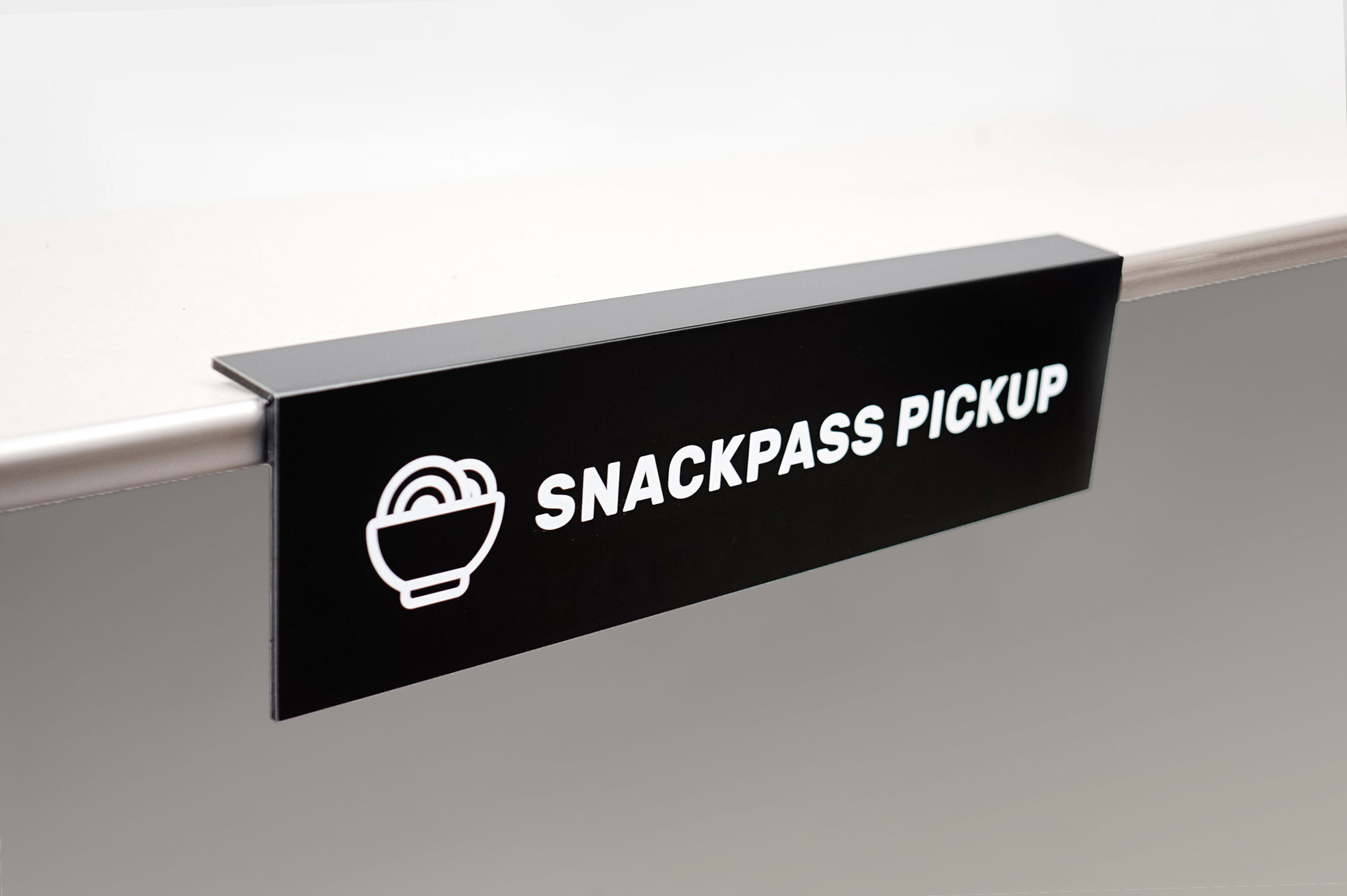 Overhanging black and white food pickup table sign for Snackpass, a social food app that makes ordering food more convenient, affordable and social. Overhanging black and white food pickup table sign for Snackpass, a social food app that makes ordering food more convenient, affordable and social.