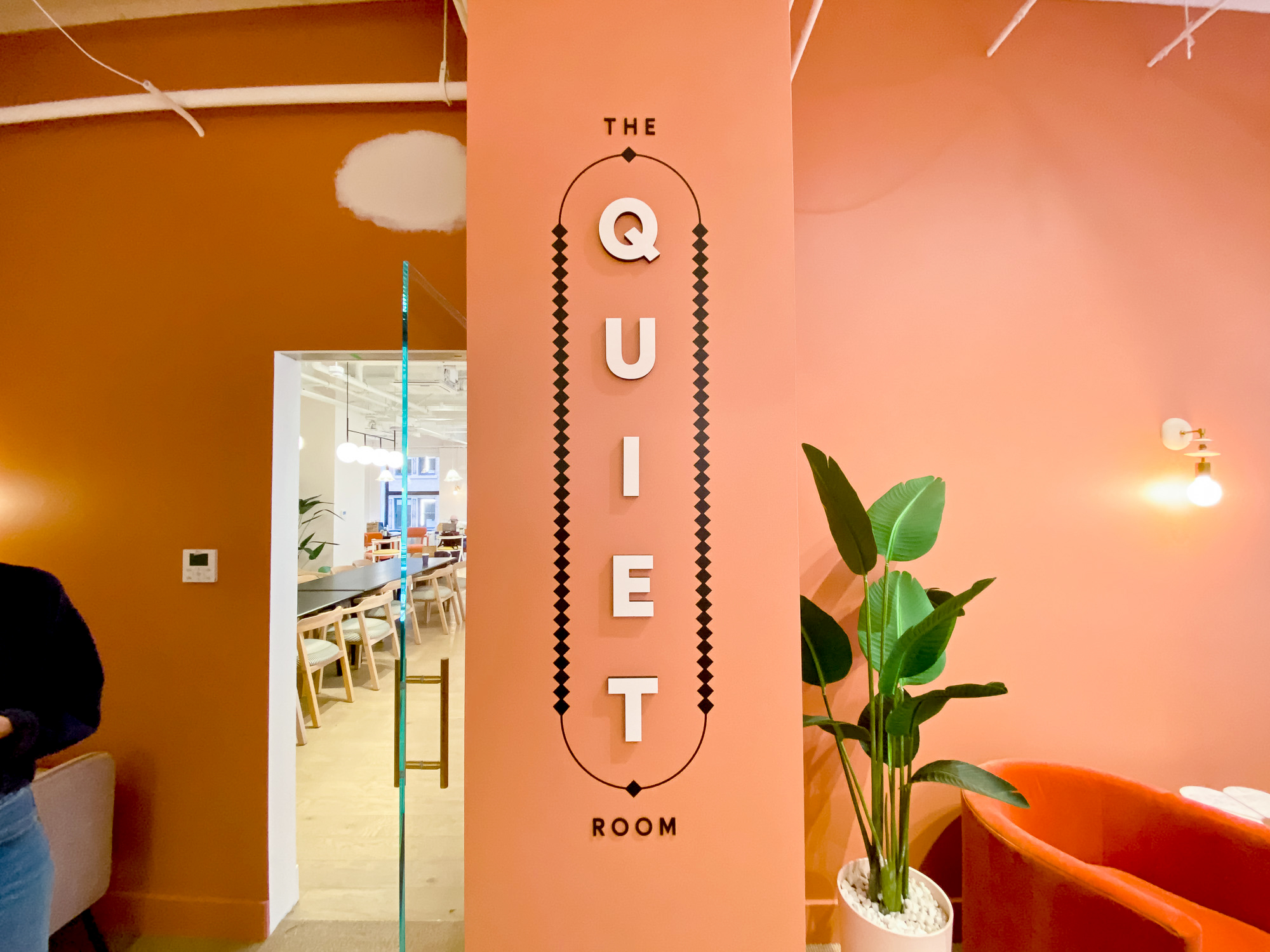 Multi-dimensional black and white “The Quiet Room” sign on salmon colored wall for the San Francisco expansion of The Wing, a network of work and community spaces designed for women. Multi-dimensional black and white