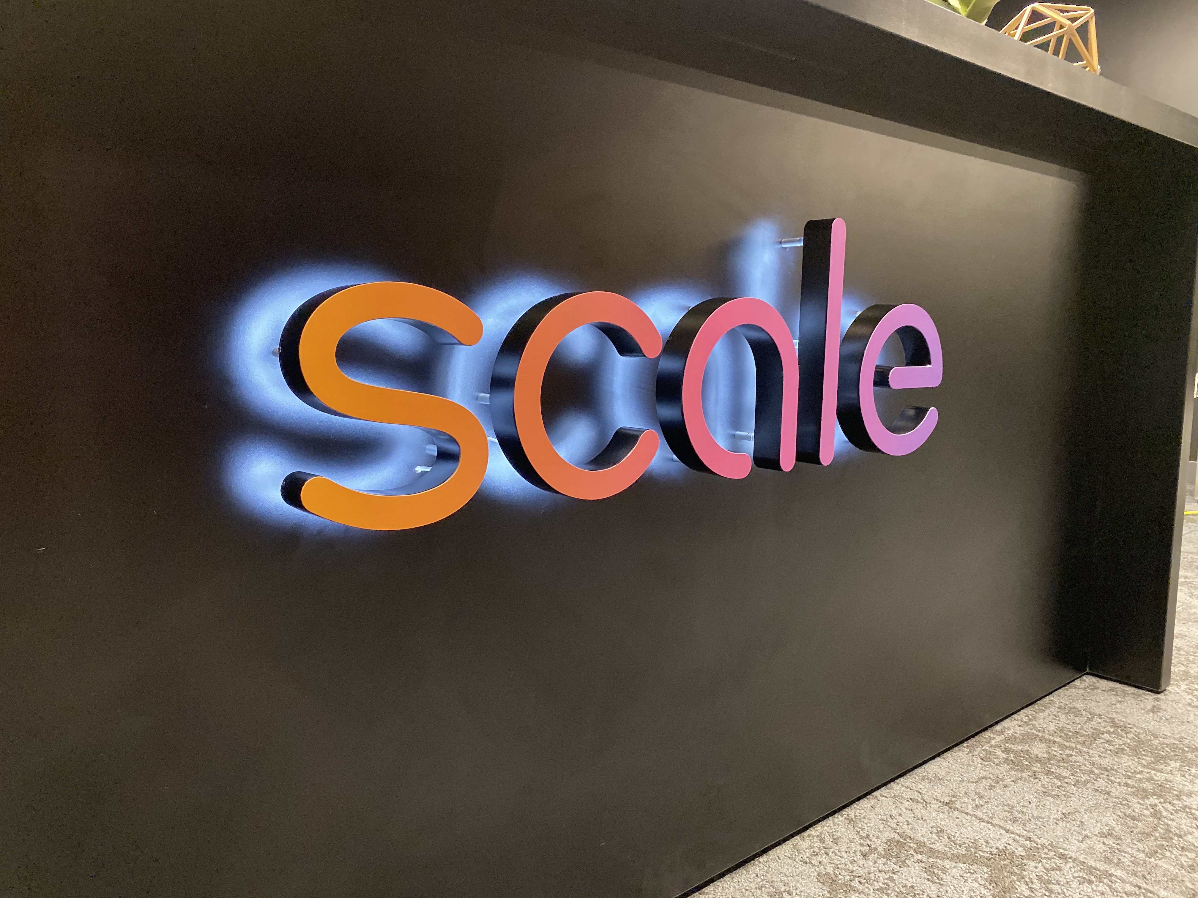 Gradient, halo-lit / back-lit illuminated sign on reception desk in the lobby of Scale, a San Francisco based company delivering high quality training data for AI applications such as self-driving cars, mapping, AR/VR, robotics, and more.