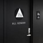 Modern, matte black restroom signs with white icons on black walls for the restrooms of Scale, a San Francisco based company delivering high quality training data for AI applications such as self-driving cars, mapping, AR/VR, robotics, and more.