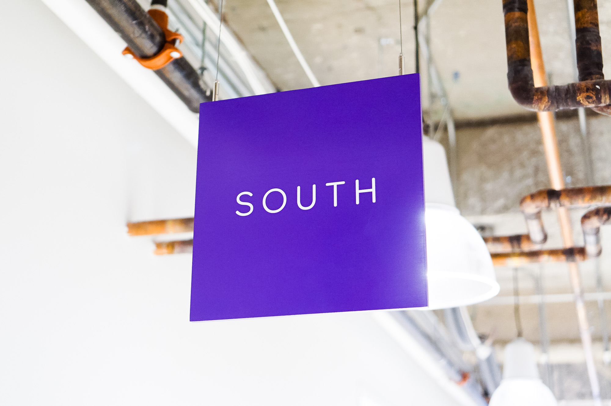 Minimal, multi-colored north, south, east, and west suspended directional signs for Scale, a San Francisco based company delivering high quality training data for AI applications such as self-driving cars, mapping, AR/VR, robotics, and more. Minimal, multi-colored north, south, east, and west suspended directional signs for Scale, a San Francisco based company delivering high quality training data for AI applications such as self-driving cars, mapping, AR/VR, robotics, and more.