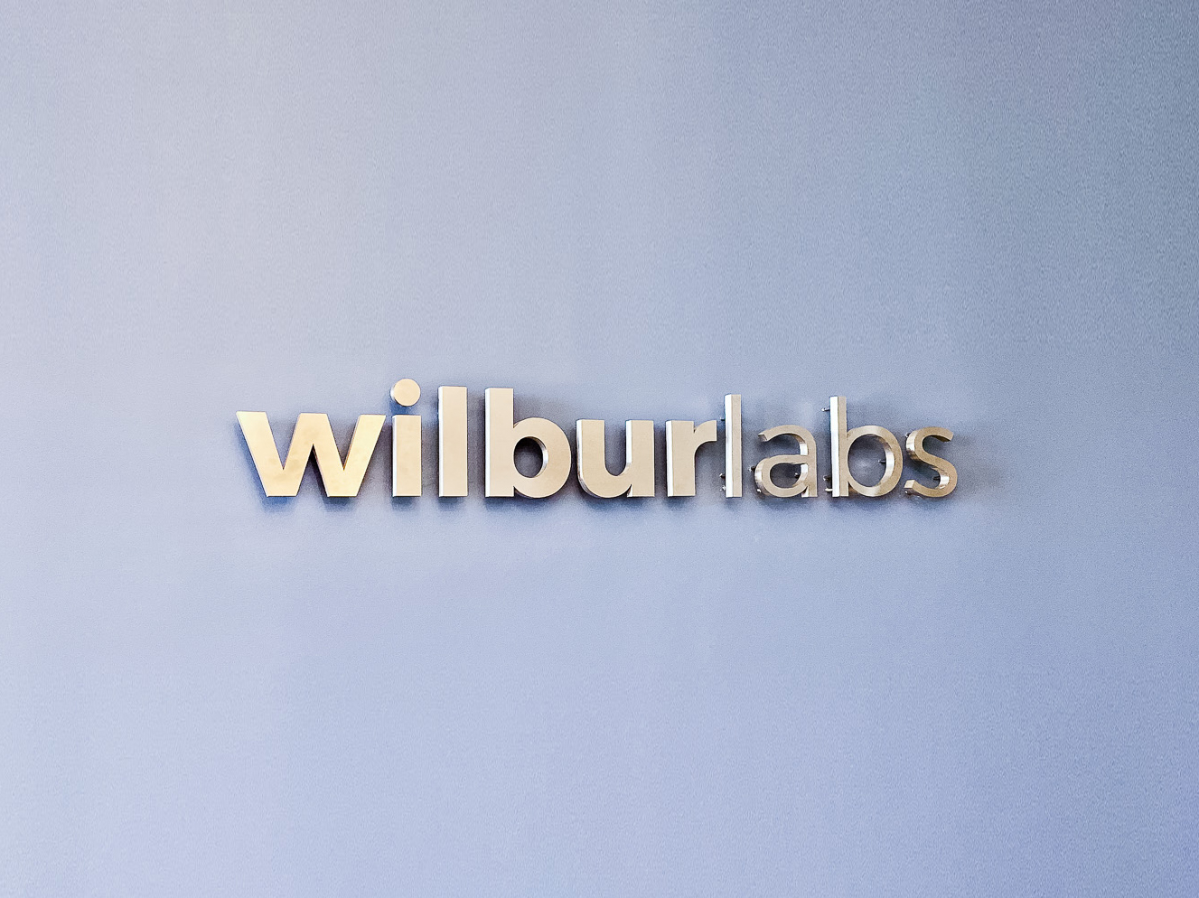 Illuminated, back-lit metal sign on slate colored wall for Wilbur Labs, a San Francisco-based startup studio building a portfolio of companies. Illuminated, back-lit metal sign on slate colored wall for Wilbur Labs, a San Francisco-based startup studio building a portfolio of companies.