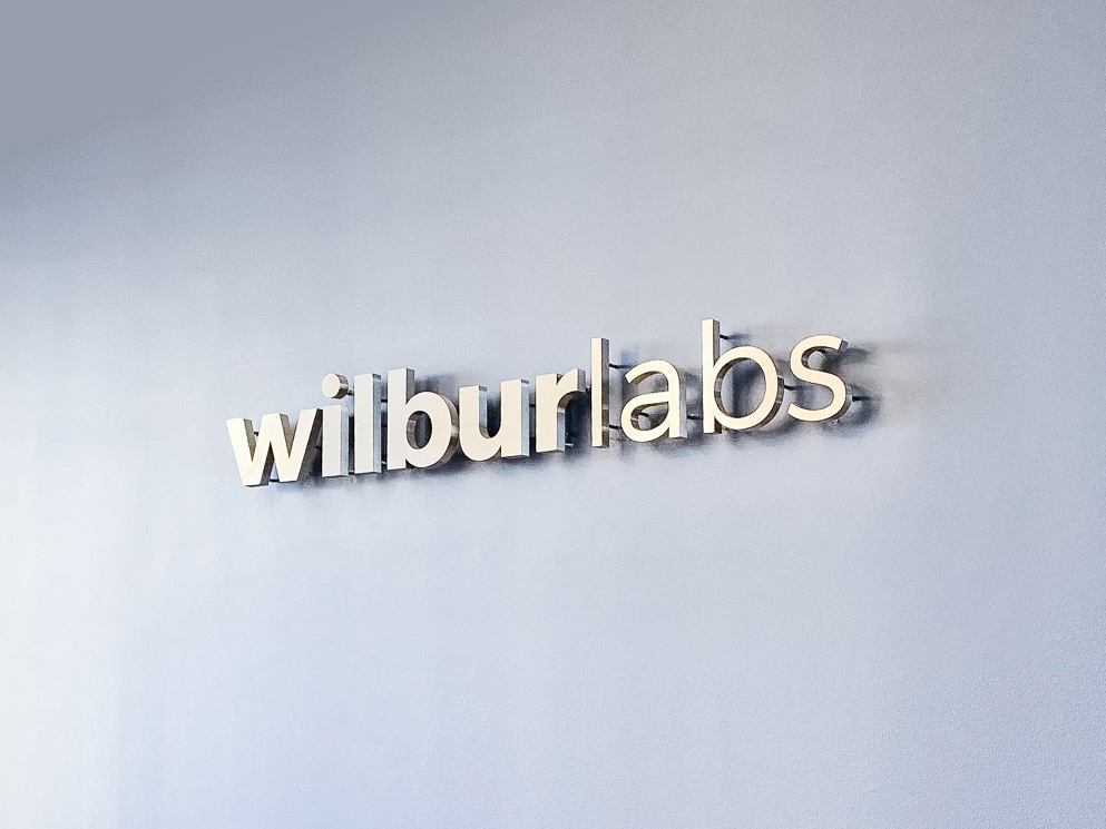Illuminated, back-lit metal sign on slate colored wall for Wilbur Labs, a San Francisco-based startup studio building a portfolio of companies. Illuminated, back-lit metal sign on slate colored wall for Wilbur Labs, a San Francisco-based startup studio building a portfolio of companies.
