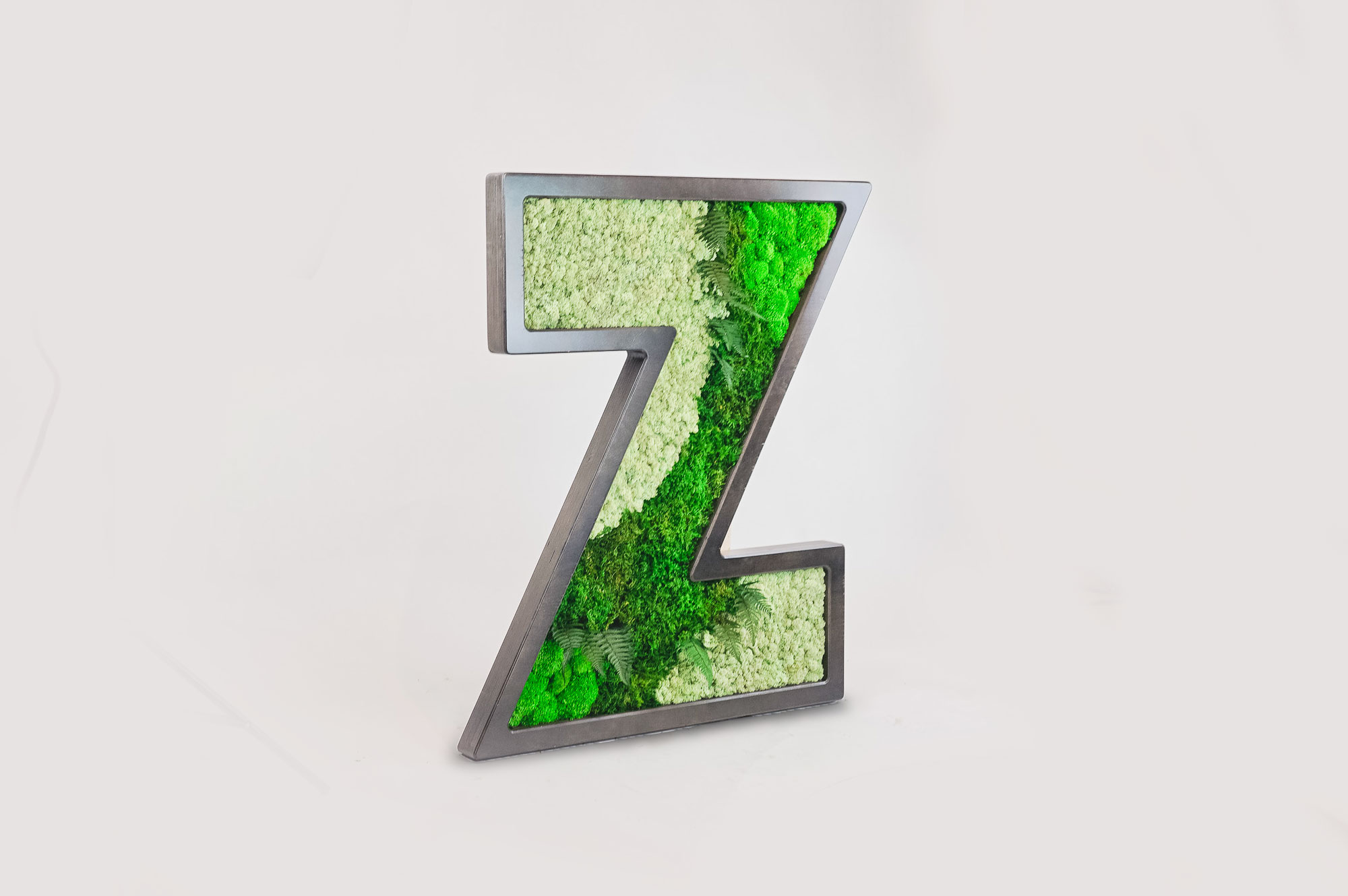 zumper-z-left Dark wood letter filled with preserved moss art for Zumper, a full-service rental platform.