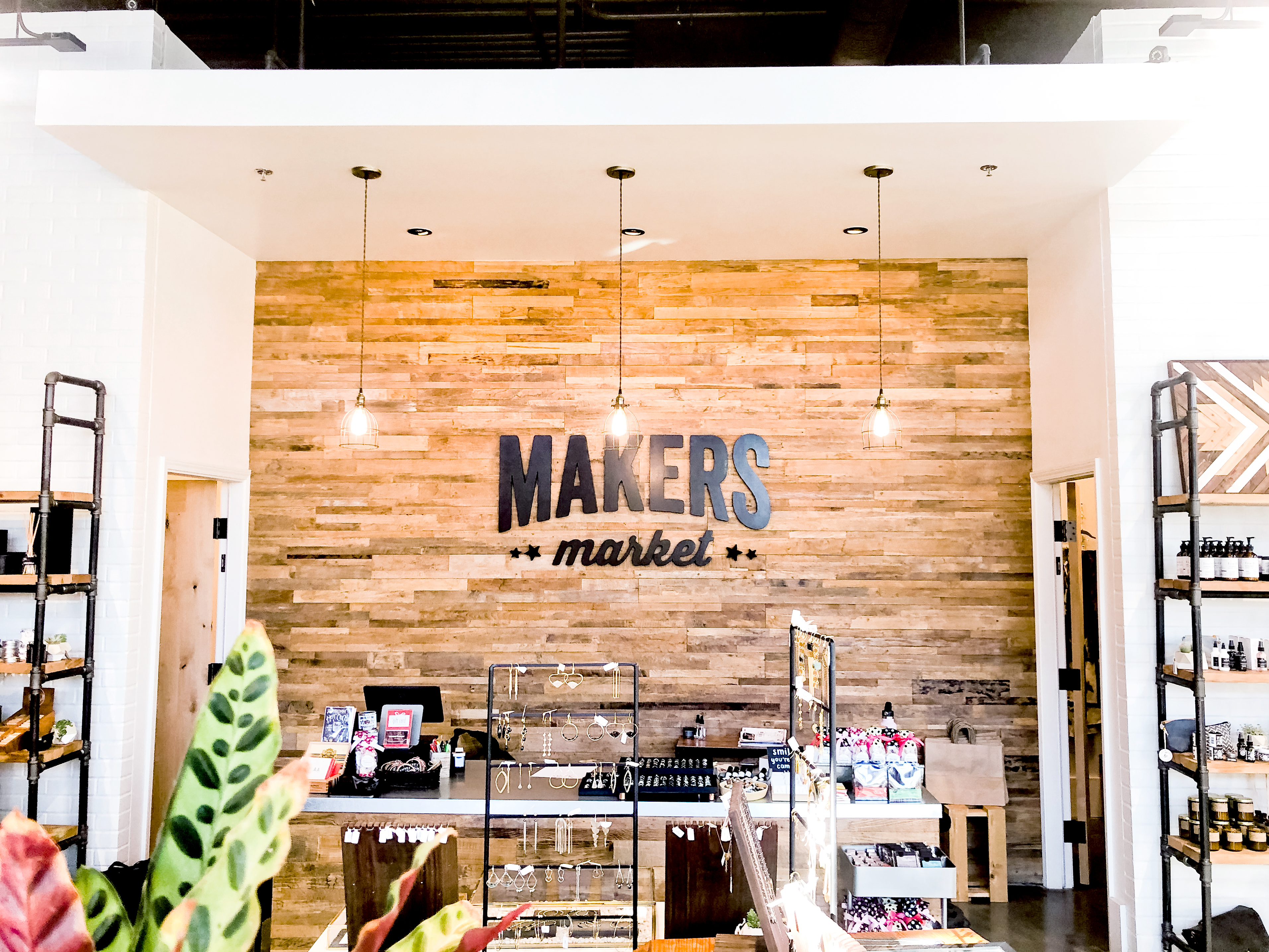Black distressed wood sign on reclaimed wood wall at the checkout stand / register area for the Napa, CA location of Makers Market, a handcrafted marketplace where you can shop the best of American made goods. Black distressed wood sign on reclaimed wood wall at the checkout stand / register area for the Napa, CA location of Makers Market, a handcrafted marketplace where you can shop the best of American made goods.